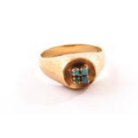 An 18ct gold and turquoise dress ring, the thick textured band and sides having concave tablet set