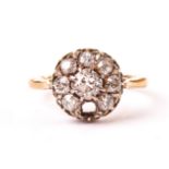 An Edwardian diamond dress ring, the circular tablet centred with an old cut stone and surrounded by