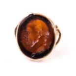 A 9ct gold and hardstone signet ring, the oval panel with intaglio bust of a Roman emporer or