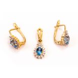 A set of 18ct gold and gem set earrings and pendant, the cluster style mounts set with a blue