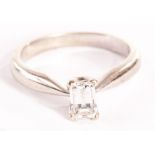 A modern diamond solitaire engagement ring, the baguette cut style stone with faceted top, approx