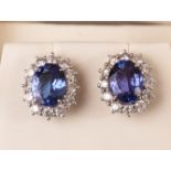 An impressive pair of tanzinite and diamond cluster earrings, each of the 18ct white gold mounts