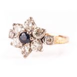 A pretty diamond and sapphire cluster dress ring, the flower head tablet set with brilliant cuts and