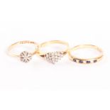 Three 18ct gold and gem set rings, including an Art Deco example, a seven stone eternity and a