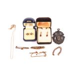 A collection of gold and gem set earrings and brooches, including several pairs of earrings, three