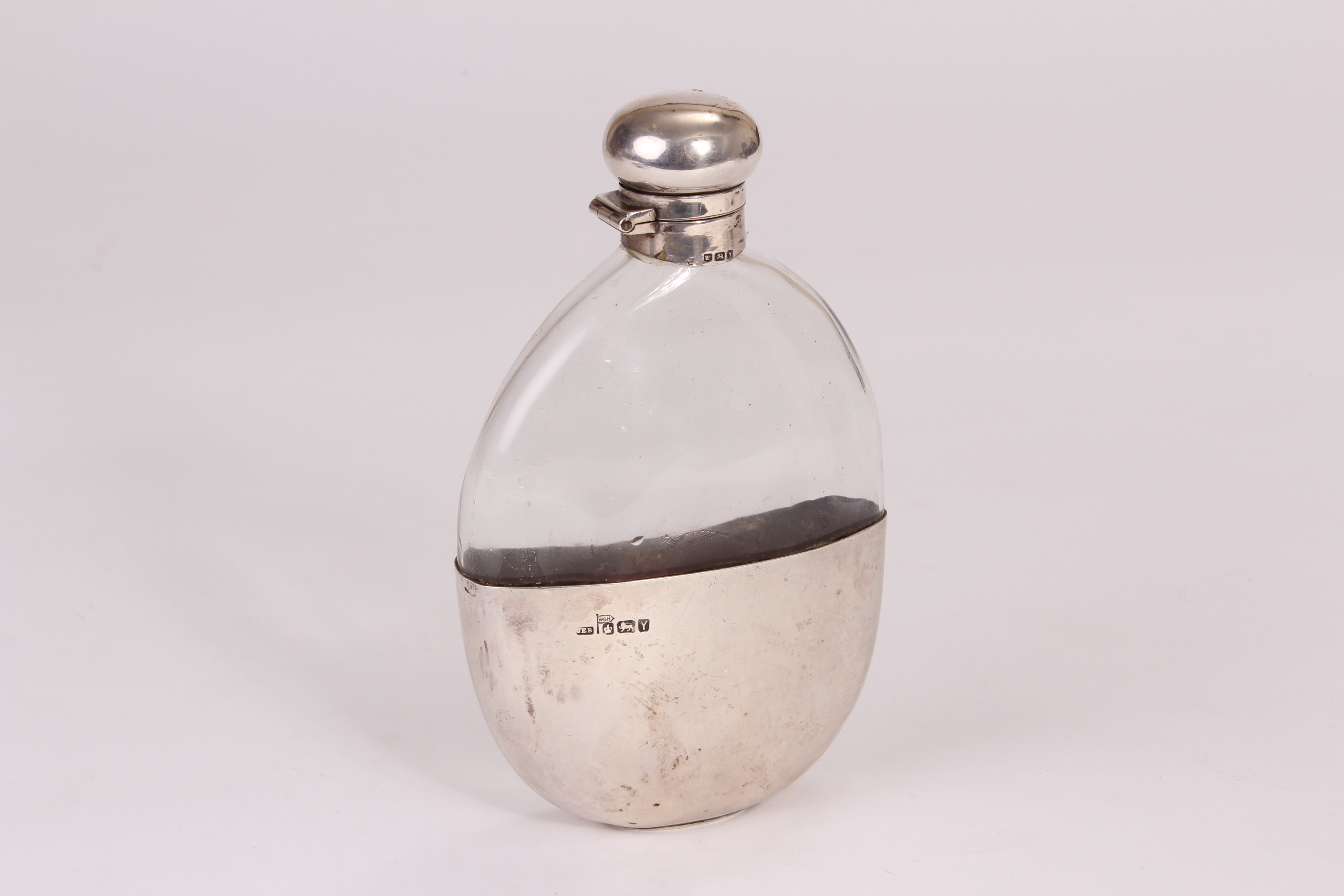 A late Victorian silver and glass hip flask from Walker & Hall, oval shaped glass vessel with silver