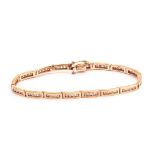 A 9ct gold and diamond line bracelet, each oblong link with four channel set brilliant cut stones,