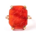 A middle eastern signet ring, the yellow metal ring and mount supporting a carved carnelian panel