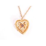 A pretty 9ct gold heart shaped locket, the front with floral design set with seed pearls and