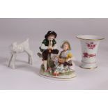 A twentieth century Sitzendorf figure group, as a young couple with flute and hurdy gurdy,