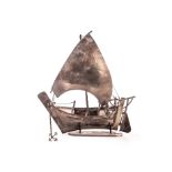 A sterling silver dhow, with Sharjah House Silver mark to the sail, and sterling mark to the hull