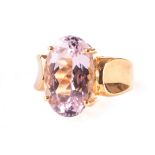 An 18ct gold and large single stone dress ring, the oval cut pink stone in four claw setting in