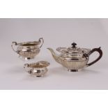 A Victorian silver three piece tea set by Goldsmiths & Silversmiths, retailed through William Gibson
