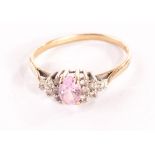 A 9ct gold and gem set ring, having pink central stone and clear stones to shoulders