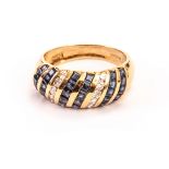 A modern 18ct gold and gem set bombe dress ring, the bulging tablet set with columns of sapphires