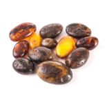 A set of Chinese beads, made out of Burmese root amber in a spectrum of colours from butterscotch,