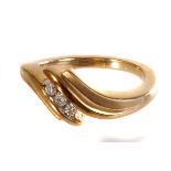 A 9ct gold diamond crossover ring, the three round cut diamond set in 9ct gold with satin finish,