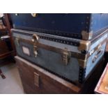 A blue travelling trunk, having brass fittings