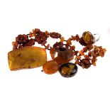 A collection of amber and amber style jewellery, including a silver dress ring, a pair of white