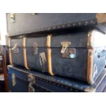 A blue travelling trunk, having brass fittings