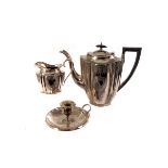 A collection of silver plated items, including a three piece coffee set, a chamber stick, flatware