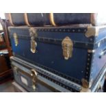 A blue travelling trunk, having brass fittings