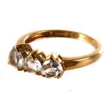 A 9ct gold and clear gem three stone ring, the three heart shaped stones set in claw mount on gold