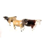 Two Beswick Jersey cow figures, together with another example marked 'of Champions' to underside (