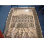 A large tapestry wall hanging, with image of a large manor house to centre, within swag design