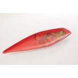 A Poole pottery Aegean dish, in the shape of a petal, having red ground and orange, green and