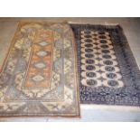 Two machine made carpets, both of beige ground, approx. 202cm by 114cm and smaller