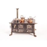 A German steel cooking range, early 20th century, with five polished steel Art Noveau oven doors