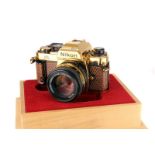 A Nikon FA Gold ‘Grand Prix ‘84’ SLR Camera, gold, serial no. 2005022, with AIS f/1.4 50mm lens,