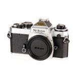 A Nikon FE SLR Body, chrome, serial no. 3004981, body, E, shutter working, in maker’s box with