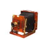 A Sanderson Tropical Mahogany Field Camera, 4½x6¼, with Beck Symmetrical f/8 brass lens, body, G,