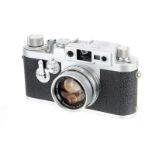 A Leica IIIg Rangefinder Camera, 1957, chrome, serial no. 825127, with Leitz Summicron f/2 50mm