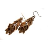 A pair of 19th century boxwood carved earrings, modelled as roses