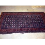 A red and brown ground Bakara carpet, having repetitive floral design, surrounded by a geometric