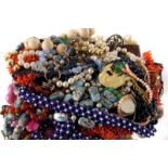 A collection of costume jewellery, including glass beads, simulated pearls, bangles, brooches and