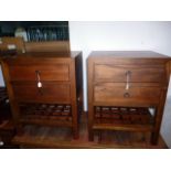 A pair of walnut bedside tables, each having two single drawers, above lower criss-cross