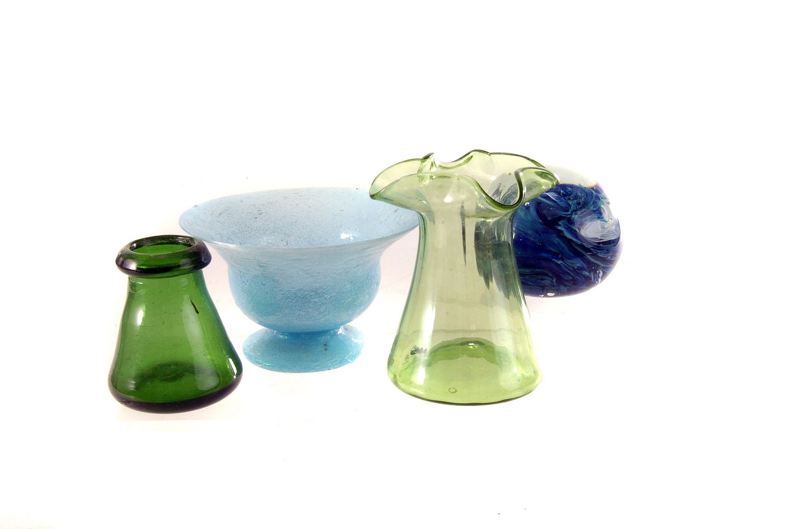 A group of coloured glass bottles, together with a selection of various other glass items, including