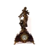 An Augustus Moreau mantle clock, the hardstone case with florally decorated dial, above a figure