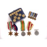 A collection of WWII medals, including the War and Defence medals, The 1939-45 star, The African