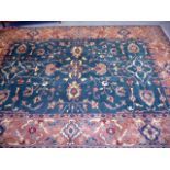 A large green ground machine knotted carpet, having central green ground florally decorated panel,