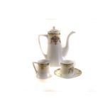 A Noritake part six setting coffee set, with floral decoration to side and blue and yellow swag