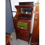 An Edwardian music cabinet, having bevelled mirrored galleried top, with two lower fold down
