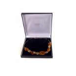An amber necklace with bolder beads, in case with certificate of authenticity from The Amber Shop
