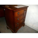 A small modern chest of drawers, having four graduated drawers, on shaped legs, approx. 64cm H
