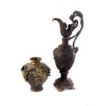 A large spelter ewer, having swag and head decoration, together with a brass vase with leaf and