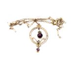 A 9ct gold, garnet and seed pearl necklace, the circular pendant having two garnet drop design, with